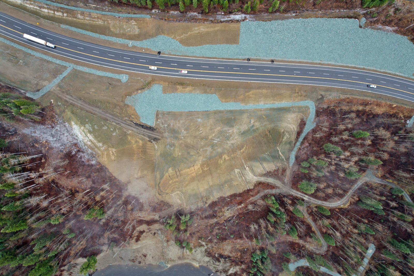 Bird’s-eye view of the Highway 97 Cottonwood Hill slide area north of Quesnel, BC, showing roadway, embankment protection, and surrounding terrain.