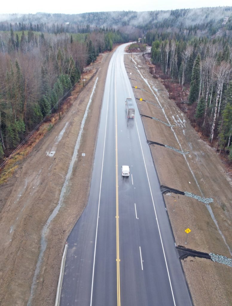 Aerial view of Highway 97 at Cottonwood Hill north of Quesnel, BC, showing vehicles travelling through the slide-affected corridor.