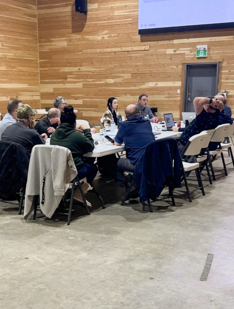 Project partners reviewing plans during a Cottonwood Hill Phase 3 project meeting near Quesnel, British Columbia.