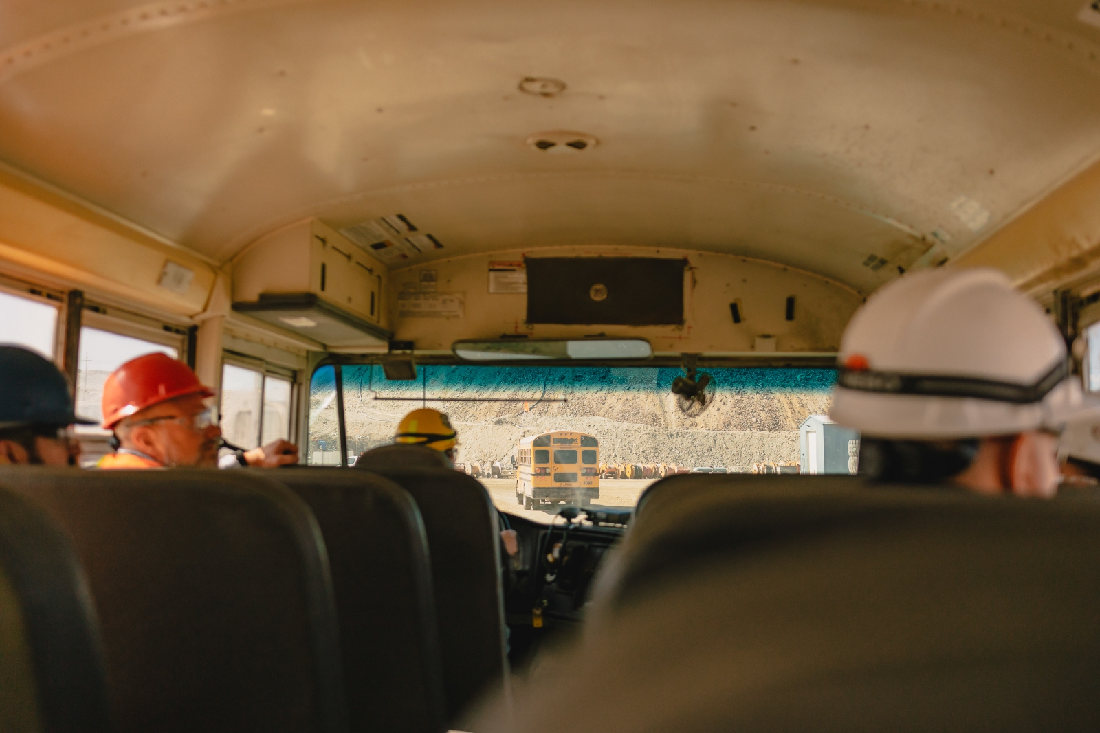 Industry representatives riding a bus through Gibraltar Mine during a guided mining industry tour in British Columbia.